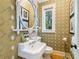 Stylish powder room with patterned wallpaper and a pedestal sink at 3382 Habersham Rd, Atlanta, GA 30305