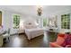 Elegant bedroom with dark hardwood floors, a comfortable bed, and ample natural light at 3382 Habersham Nw Rd, Atlanta, GA 30305