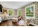 Charming bedroom with floral wallpaper, hardwood floors, and two armchairs at 3382 Habersham Nw Rd, Atlanta, GA 30305