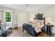 bedroom with antique bed, patterned wallpaper, and a charming sitting area at 3382 Habersham Rd, Atlanta, GA 30305