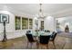 Elegant dining room with hardwood floors, a glass-top table, and chandelier at 3382 Habersham Nw Rd, Atlanta, GA 30305