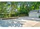 Spacious concrete driveway with landscaping and detached garage at 3382 Habersham Nw Rd, Atlanta, GA 30305