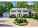 Stunning white two-story home with circular driveway and manicured landscaping at 3382 Habersham Nw Rd, Atlanta, GA 30305