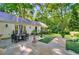 Stone patio with seating area, surrounded by lush landscaping at 3382 Habersham Nw Rd, Atlanta, GA 30305