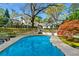 Inviting kidney-shaped pool surrounded by a spacious patio and mature trees at 3382 Habersham Rd, Atlanta, GA 30305