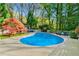 Relaxing kidney-shaped pool with a large patio area perfect for entertaining at 3382 Habersham Nw Rd, Atlanta, GA 30305