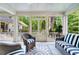 Spacious screened porch, perfect for relaxing, with stylish striped seating at 3382 Habersham Rd, Atlanta, GA 30305