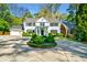 Beautiful two-story home with a circular driveway, manicured shrubs, and a classic black and white facade at 3382 Habersham Rd, Atlanta, GA 30305