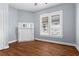 Bright bedroom featuring hardwood floors and a decorative fireplace at 135 Adair Se Ave, Atlanta, GA 30315