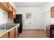 Efficient kitchen featuring wood cabinets, tile floors, and a window at 135 Adair Se Ave, Atlanta, GA 30315