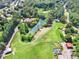 Aerial view of property featuring a pond, expansive greenery, and mature trees at 3505 Watson Rd, Cumming, GA 30028