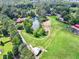 An aerial shot showcases the home's pond, surrounded by trees and sprawling green space at 3505 Watson Rd, Cumming, GA 30028