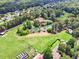 Aerial view of home situated on a large lot with a pond, surrounded by trees at 3505 Watson Rd, Cumming, GA 30028