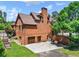 The rear exterior showcases a brick design, a three-car garage, and a well-maintained lawn and landscape at 3505 Watson Rd, Cumming, GA 30028