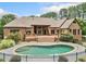 Brick home featuring an expansive deck and fenced in-ground pool, set within a landscaped yard at 3505 Watson Rd, Cumming, GA 30028