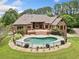 Aerial view of a brick home showcasing a large deck and fenced pool, perfect for outdoor enjoyment at 3505 Watson Rd, Cumming, GA 30028