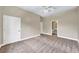 Bedroom with neutral walls and carpet flooring leading to bathroom with sink, toilet, and shower at 3505 Watson Rd, Cumming, GA 30028