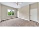 A bright, carpeted bedroom with a ceiling fan and a window with a view at 3505 Watson Rd, Cumming, GA 30028