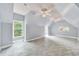 Bright bonus room with light grey paint, tile flooring, dormer windows, and ceiling fans at 3505 Watson Rd, Cumming, GA 30028