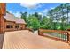 Wooden deck offers access to the in-ground pool and views of the brick home at 3505 Watson Rd, Cumming, GA 30028