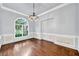 Elegant dining room featuring a large arched window, chandelier, and classic trimwork at 3505 Watson Rd, Cumming, GA 30028