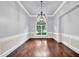 Bright dining room features a large arched window, hardwood floors, and classic trimwork at 3505 Watson Rd, Cumming, GA 30028