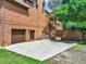 Brick home featuring a two-car garage, stone retaining wall, and mature trees at 3505 Watson Rd, Cumming, GA 30028