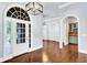 Bright foyer featuring a beautiful front door, hardwood floors, and stylish lighting at 3505 Watson Rd, Cumming, GA 30028