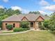 A single-Gathering home, beautifully landscaped, with a brick exterior, lush lawn, and concrete walkway at 3505 Watson Rd, Cumming, GA 30028