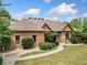 A single-Gathering home, beautifully landscaped, with a brick exterior and a concrete walkway at 3505 Watson Rd, Cumming, GA 30028