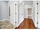 Hallway with hardwood floors and tile, offering a seamless transition between rooms at 3505 Watson Rd, Cumming, GA 30028