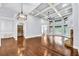 Open-concept living room with a fireplace, bar, and large windows at 3505 Watson Rd, Cumming, GA 30028