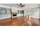 Spacious living room features hardwood floors, fireplace, built-in shelving, and modern ceiling fan at 3505 Watson Rd, Cumming, GA 30028