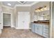 Elegant main bathroom with dual vanities, granite countertops, and travertine tile floors at 3505 Watson Rd, Cumming, GA 30028