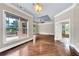 Serene main bedroom with tray ceiling, hardwood floors, and access to a private balcony at 3505 Watson Rd, Cumming, GA 30028