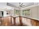 Bright main bedroom with large windows, hardwood floors, and tray ceiling with fan at 3505 Watson Rd, Cumming, GA 30028