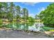 Scenic view of a tranquil pond reflecting the surrounding trees and sky on a sunny day at 3505 Watson Rd, Cumming, GA 30028