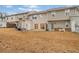 Townhome backyard with patio, grassy area, and neighboring townhomes at 438 Lantern Wood Dr, Scottdale, GA 30079