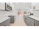 Modern kitchen with gray and white cabinets and quartz countertops at 438 Lantern Wood Dr, Scottdale, GA 30079