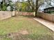 Large, level backyard with a new privacy fence, lush green grass, and a small patio at 701 Cameron M Alexander Nw Blvd, Atlanta, GA 30318