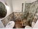 Bathroom featuring a stand up shower with decorative stone and glass door, pedestal sink, and an oval mirror at 701 Cameron M Alexander Nw Blvd, Atlanta, GA 30318