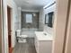 Bathroom featuring bath and shower, vanity and wood look flooring at 701 Cameron M Alexander Nw Blvd, Atlanta, GA 30318