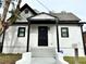 Charming home with a black door, fresh white paint and contrasting black trim at 701 Cameron M Alexander Nw Blvd, Atlanta, GA 30318