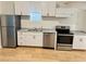 Kitchen featuring stainless appliances, granite countertops and white cabinets at 701 Cameron M Alexander Nw Blvd, Atlanta, GA 30318