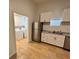 Kitchen featuring stainless appliances, granite countertops and white cabinets; laundry in background at 701 Cameron M Alexander Nw Blvd, Atlanta, GA 30318