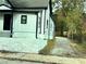 Exterior shot of home featuring well-maintained siding and a gravel driveway at 701 Cameron M Alexander Nw Blvd, Atlanta, GA 30318