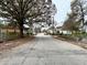 A quiet, tree-lined street showcases the neighborhood and community atmosphere of this home at 701 Cameron M Alexander Nw Blvd, Atlanta, GA 30318