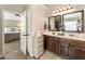 Elegant bathroom with double vanity and a view of the bedroom at 1590 Walking Horse Trl, Cumming, GA 30041