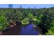 Aerial view of a serene lake surrounded by lush trees, with the city skyline visible in the distance at 250 Lakeview Ne Ave, Atlanta, GA 30305