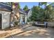 Wide shot of back patio with stone fireplace, bench and chair seating, and concrete pad at 250 Lakeview Ne Ave, Atlanta, GA 30305